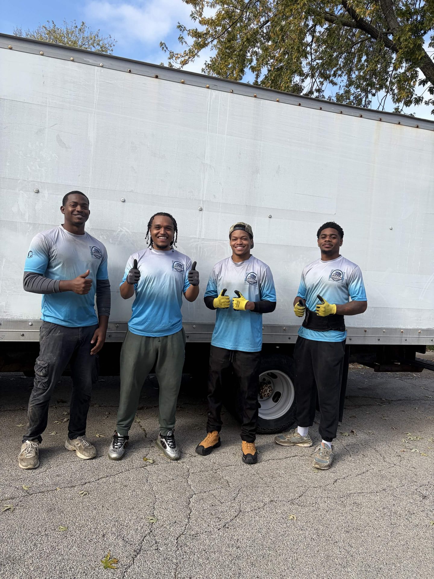 ShirBak crew standing beside their moving truck.
